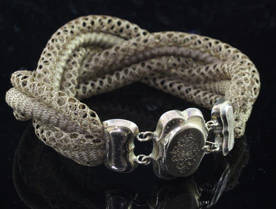 A Victorian plaited hair mourning bracelet with engraved gold and base metal clasp, 7.25in.